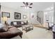 The carpeted living room features neutral paint, furnishings, and a staircase visible in the background at 4526 Warren Mill Trl, Ellenwood, GA 30294