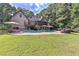 Spacious backyard featuring a private pool, patio area, and mature trees for ultimate relaxation at 1230 Mars Hill Nw Rd, Acworth, GA 30101