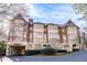 Exterior view of the condo building with a covered entrance and lovely landscaping at 1717 N Decatur Ne Rd # 322, Atlanta, GA 30307