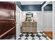 Stylish hallway featuring checkerboard tile flooring, decorative chest, and attractive wall decor at 1717 N Decatur Ne Rd # 322, Atlanta, GA 30307