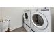 Bright laundry area showcasing modern washer and dryer units with tile floor at 1717 N Decatur Ne Rd # 322, Atlanta, GA 30307