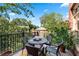 Outdoor patio with a dining table surrounded by lush greenery and shade at 1717 N Decatur Ne Rd # 322, Atlanta, GA 30307