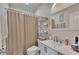 Clean bathroom with a shower-tub combination and organized shelving at 213 Augusta Walk, Canton, GA 30114