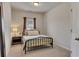 Cozy bedroom with a metal frame bed, side table, and carpeted floors at 213 Augusta Walk, Canton, GA 30114