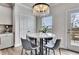 Cozy breakfast nook featuring a marble-top table, modern lighting, and access to the outdoor deck at 213 Augusta Walk, Canton, GA 30114