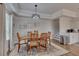 Dining area with wooden table and chairs set on patterned rug with natural light at 213 Augusta Walk, Canton, GA 30114