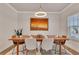 Bright dining room featuring a modern light fixture and a large window with natural light at 213 Augusta Walk, Canton, GA 30114