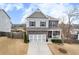 Charming two-story home with stone accents, a well-manicured lawn, and a welcoming front porch at 213 Augusta Walk, Canton, GA 30114