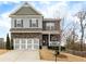 Charming two-story home with stone accents, neutral siding, large driveway, and manicured landscaping at 213 Augusta Walk, Canton, GA 30114