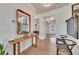 Inviting foyer with hardwood floors, decorative table, and a view of the staircase and front door at 213 Augusta Walk, Canton, GA 30114