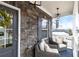 Cozy front porch with stone exterior, seating, and stylish lighting, creating an inviting entrance at 213 Augusta Walk, Canton, GA 30114