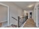 Upstairs hallway with wood floors and metal decorative banister at 213 Augusta Walk, Canton, GA 30114