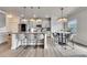 Modern kitchen with stainless steel appliances, a granite island with seating, and pendant lighting at 213 Augusta Walk, Canton, GA 30114