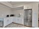 Modern kitchen with stainless steel appliances, white cabinets, and a neutral backsplash at 213 Augusta Walk, Canton, GA 30114