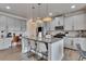 Modern kitchen boasts granite countertops, stainless steel appliances, and a large island with bar seating at 213 Augusta Walk, Canton, GA 30114