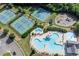 Aerial view of the community tennis courts, playground, and pool near a home in a gated community at 213 Augusta Walk, Canton, GA 30114