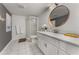 Bathroom with a large white vanity, round mirror, modern lighting, and a walk-in shower at 2384 Defoors Ferry Nw Rd, Atlanta, GA 30318