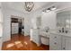 This bathroom features a vanity and large mirror with hardwood floors at 2384 Defoors Ferry Nw Rd, Atlanta, GA 30318