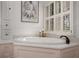 A close up of the large jacuzzi tub in the bathroom with hardwood floors at 2384 Defoors Ferry Nw Rd, Atlanta, GA 30318