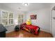 A fun bedroom, featuring a car-shaped bed, hardwood floors, and a colorful cartoon wall art at 2384 Defoors Ferry Nw Rd, Atlanta, GA 30318