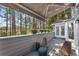 Deck area with awning, stylish outdoor chairs, and flower boxes with a beautiful wooded view at 2384 Defoors Ferry Nw Rd, Atlanta, GA 30318