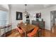 Dining room featuring hardwood floors, stylish furniture, a decorative light fixture, and ample natural light at 2384 Defoors Ferry Nw Rd, Atlanta, GA 30318