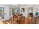 Bright dining room featuring hardwood floors, large windows, stylish furniture, and a decorative light fixture at 2384 Defoors Ferry Nw Rd, Atlanta, GA 30318