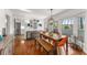 Bright dining room featuring hardwood floors, large windows, stylish furniture, and an open layout at 2384 Defoors Ferry Nw Rd, Atlanta, GA 30318