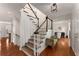 Inviting foyer with wood stairs, hardwood floors, white walls, and a view of the living spaces at 2384 Defoors Ferry Nw Rd, Atlanta, GA 30318