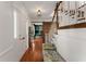 Elegant entry foyer with hardwood floors, wooden staircase, and view into the green painted office at 2384 Defoors Ferry Nw Rd, Atlanta, GA 30318