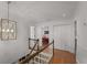 Bright hallway featuring hardwood floors, white walls, and an eye-catching hanging light fixture at 2384 Defoors Ferry Nw Rd, Atlanta, GA 30318