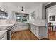 Bright kitchen featuring white cabinets, stainless steel appliances, a farmhouse sink, and an open layout at 2384 Defoors Ferry Nw Rd, Atlanta, GA 30318