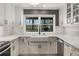 Bright kitchen with white cabinets, stainless steel appliances, and a large farmhouse sink beneath a window at 2384 Defoors Ferry Nw Rd, Atlanta, GA 30318