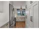 Spacious kitchen featuring stainless steel refrigerator, range, and white cabinets with a farmhouse sink at 2384 Defoors Ferry Nw Rd, Atlanta, GA 30318