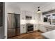 Modern kitchen with stainless steel appliances, a farmhouse sink, white cabinets, and ample counter space at 2384 Defoors Ferry Nw Rd, Atlanta, GA 30318