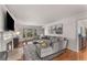 Elegant living room features hardwood floors, a fireplace, a large bay window, and modern gray furniture at 2384 Defoors Ferry Nw Rd, Atlanta, GA 30318