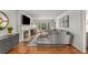 Elegant living room features hardwood floors, a fireplace, a large bay window, and modern gray furniture at 2384 Defoors Ferry Nw Rd, Atlanta, GA 30318