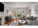 Comfortable living room with a fireplace, a bay window offering natural light, and stylish, modern furniture at 2384 Defoors Ferry Nw Rd, Atlanta, GA 30318