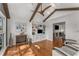 Bright living room featuring hardwood floors, wood beams, built-in bookshelves, and a fireplace view at 2384 Defoors Ferry Nw Rd, Atlanta, GA 30318