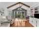 Bright living room featuring hardwood floors, wood beams, and a large window with backyard view at 2384 Defoors Ferry Nw Rd, Atlanta, GA 30318