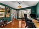 A well-appointed office with hardwood floors, natural light, dark green walls, and classic decor at 2384 Defoors Ferry Nw Rd, Atlanta, GA 30318