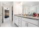 Bathroom with dual sinks, granite countertops, and tiled floors at 855 Venture Sw Way, Atlanta, GA 30331