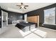 Large bedroom with neutral carpet, dark accent wall, and a ceiling fan at 855 Venture Sw Way, Atlanta, GA 30331