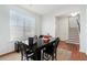 Bright dining area with hardwood floors, a dark wood table set, and a window offering plenty of natural light at 855 Venture Sw Way, Atlanta, GA 30331