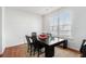 Cozy dining area with a dark wood table, complemented by a jute rug and natural light from a large window at 855 Venture Sw Way, Atlanta, GA 30331