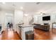 Open concept kitchen with stainless appliances, granite countertops, and hardwood floors flowing into the living room at 855 Venture Sw Way, Atlanta, GA 30331