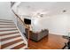 Bright living room showcasing hardwood floors, a staircase, and a comfortable couch with a mounted television at 855 Venture Sw Way, Atlanta, GA 30331