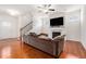 Open living area featuring hardwood floors, a fireplace, a large couch, and stairs leading to the upper level at 855 Venture Sw Way, Atlanta, GA 30331