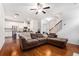 Open-concept living room with hardwood floors, seamlessly flowing into the kitchen and staircase to the upper level at 855 Venture Sw Way, Atlanta, GA 30331