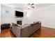 Comfortable living room with hardwood floors, a fireplace, and a large sectional couch under a ceiling fan at 855 Venture Sw Way, Atlanta, GA 30331